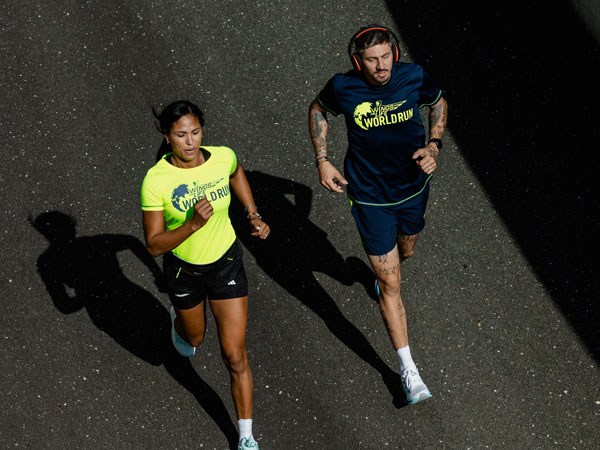 To l&oslash;pere som kjemper for &aring; holde seg foran f&oslash;lgebilen.